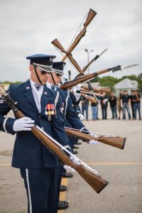 Officers doing salutes with rifles