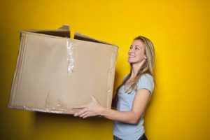 woman carries a box