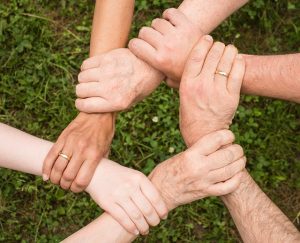 People holding their hands as a sign of a team spirit.