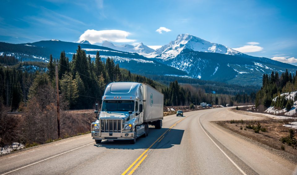 a truck on a road, representing eco-friendly moving tips