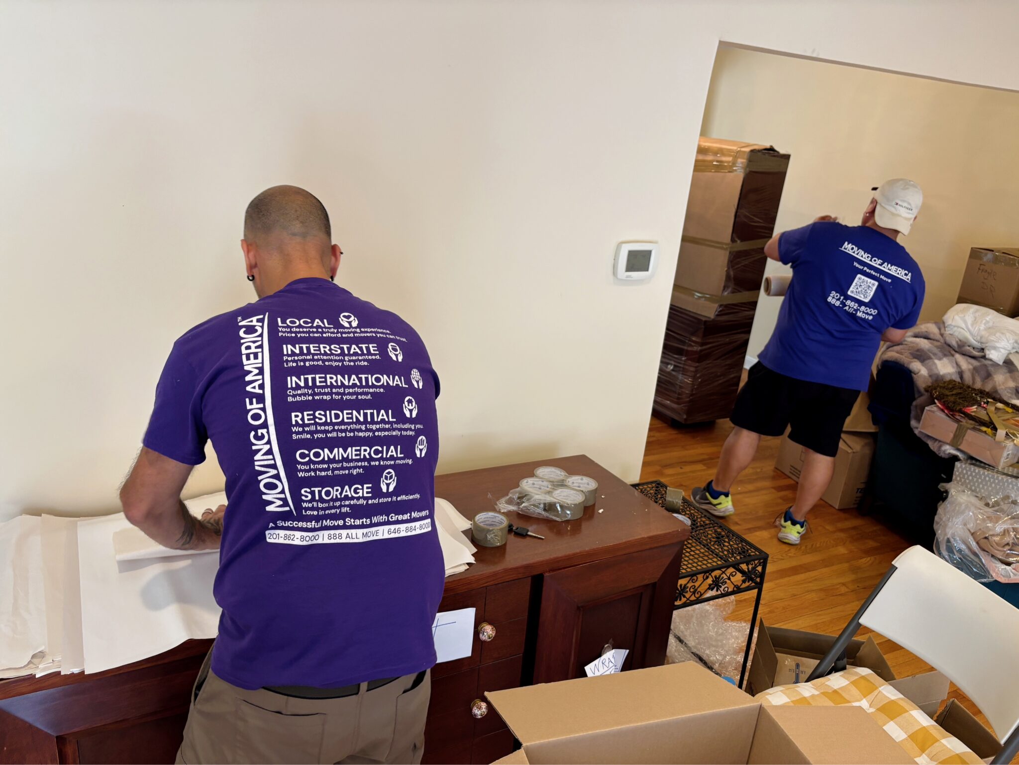 Professional movers packing belongings for long-term storage in NJ.