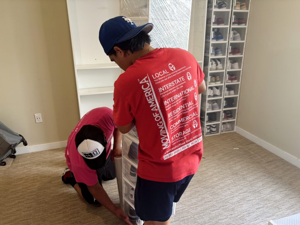 Experienced New York City movers carrying furniture during an apartment move.