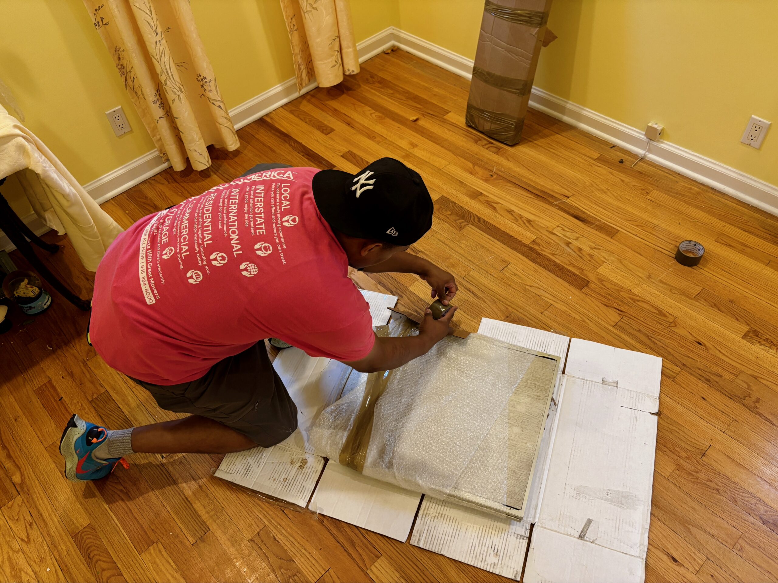 Senior movers in New Jersey carefully assisting an older adult with packing and preparing household items for a safe relocation.